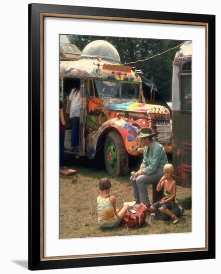 Man Seated with Two Young Boys in Front of a Wildly Painted School Bus, Woodstock Music Art Fest-John Dominis-Framed Photographic Print