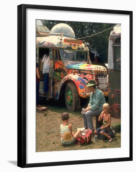 Man Seated with Two Young Boys in Front of a Wildly Painted School Bus, Woodstock Music Art Fest-John Dominis-Framed Photographic Print