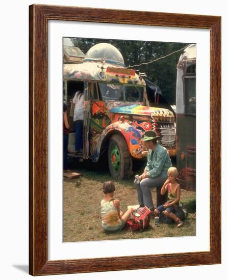 Man Seated with Two Young Boys in Front of a Wildly Painted School Bus, Woodstock Music Art Fest-John Dominis-Framed Photographic Print