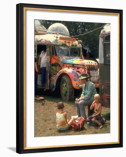 Man Seated with Two Young Boys in Front of a Wildly Painted School Bus, Woodstock Music Art Fest-John Dominis-Framed Photographic Print