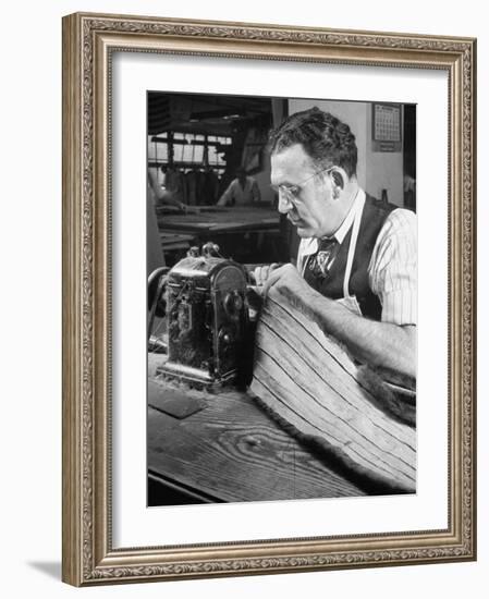 Man Sewing Strips of Fur Together-Dmitri Kessel-Framed Photographic Print