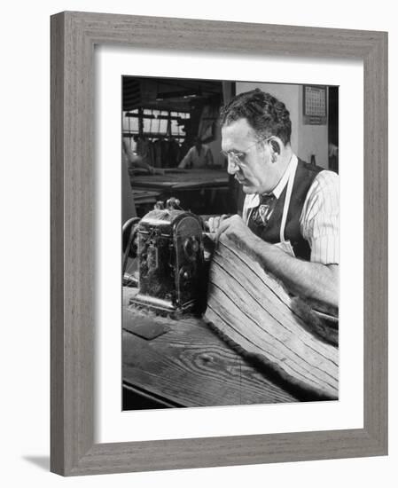 Man Sewing Strips of Fur Together-Dmitri Kessel-Framed Photographic Print