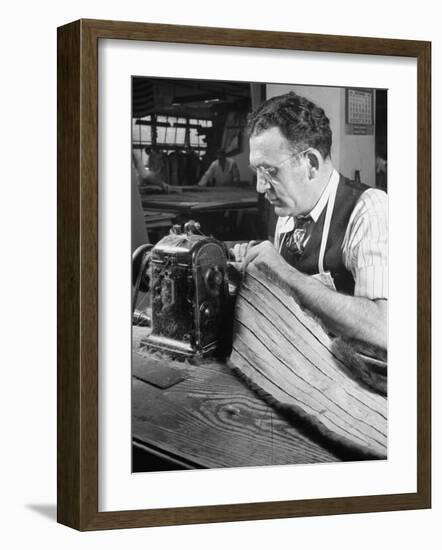 Man Sewing Strips of Fur Together-Dmitri Kessel-Framed Photographic Print