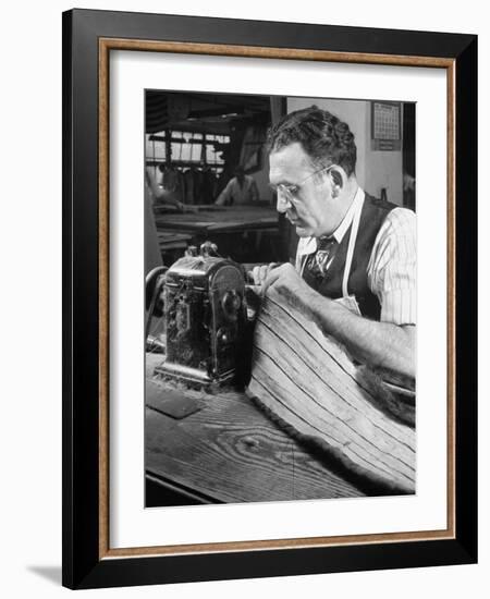 Man Sewing Strips of Fur Together-Dmitri Kessel-Framed Photographic Print