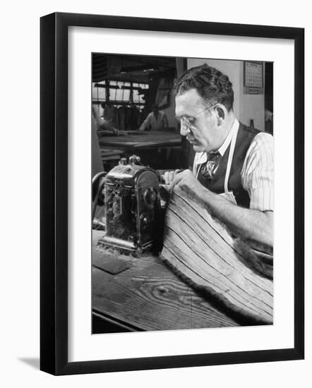 Man Sewing Strips of Fur Together-Dmitri Kessel-Framed Photographic Print
