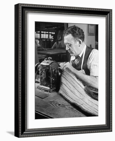 Man Sewing Strips of Fur Together-Dmitri Kessel-Framed Photographic Print