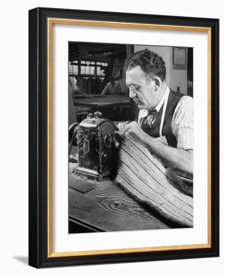 Man Sewing Strips of Fur Together-Dmitri Kessel-Framed Photographic Print