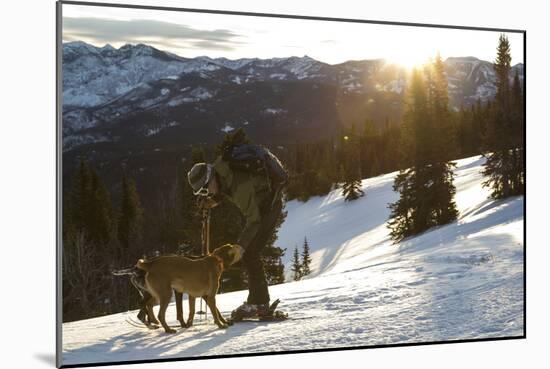 Man Shows His Dogs Affection Before A Morning Backcountry Ski In Montana's Gallatin Range-Hannah Dewey-Mounted Photographic Print