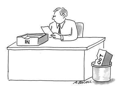 Man Sitting At Desk With In Box On Desk And Out Box In Trash