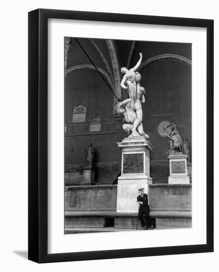 Man Sitting Beneath Statue of Giambologna's "Rape of the Sabine" in Loggia Dei Lanzi-Carl Mydans-Framed Photographic Print