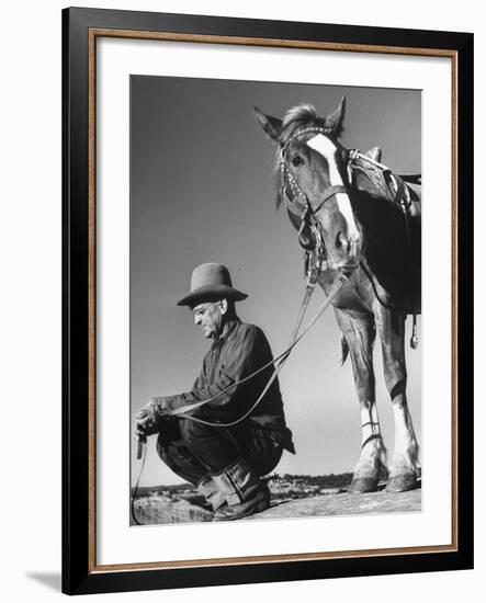 Man Sitting Holding His Horses Reins-Loomis Dean-Framed Photographic Print