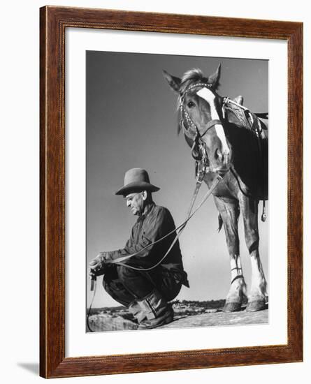 Man Sitting Holding His Horses Reins-Loomis Dean-Framed Photographic Print