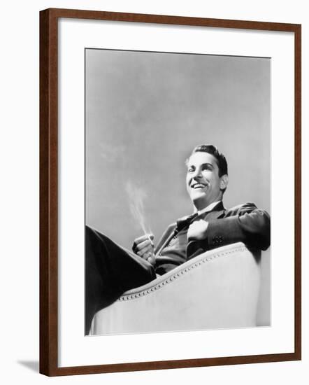 Man Sitting in an Arm Chair Smoking-null-Framed Photo