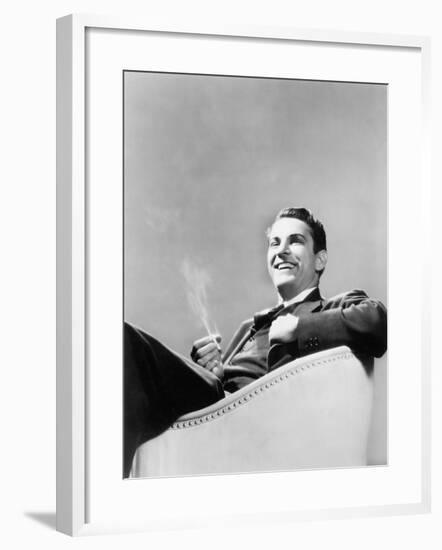 Man Sitting in an Arm Chair Smoking-null-Framed Photo