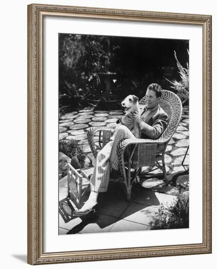 Man Sitting in Chair Outside with Dog-null-Framed Photo