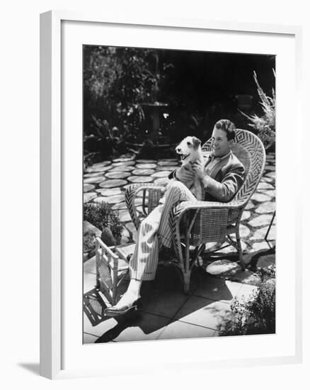 Man Sitting in Chair Outside with Dog-null-Framed Photo