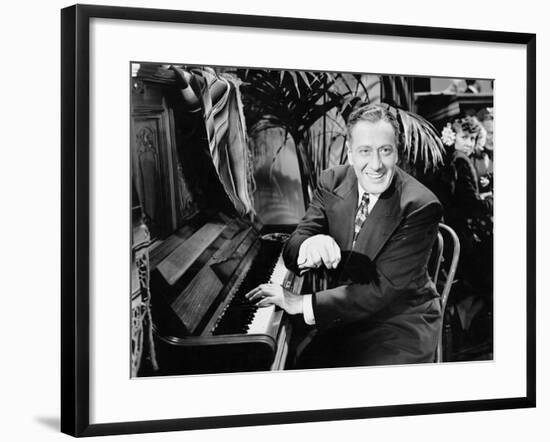 Man Sitting Next to a Piano-null-Framed Photo