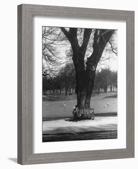 Man Sitting on a Bench and Reading a Newspaper in the Park-Cornell Capa-Framed Photographic Print