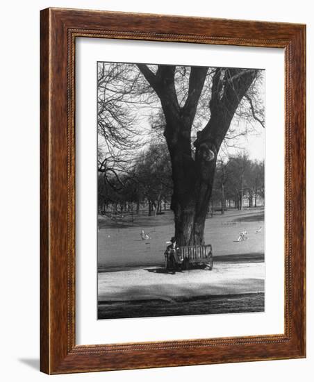 Man Sitting on a Bench and Reading a Newspaper in the Park-Cornell Capa-Framed Photographic Print