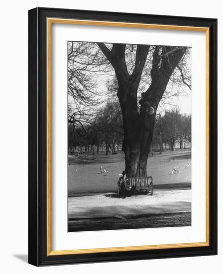 Man Sitting on a Bench and Reading a Newspaper in the Park-Cornell Capa-Framed Photographic Print