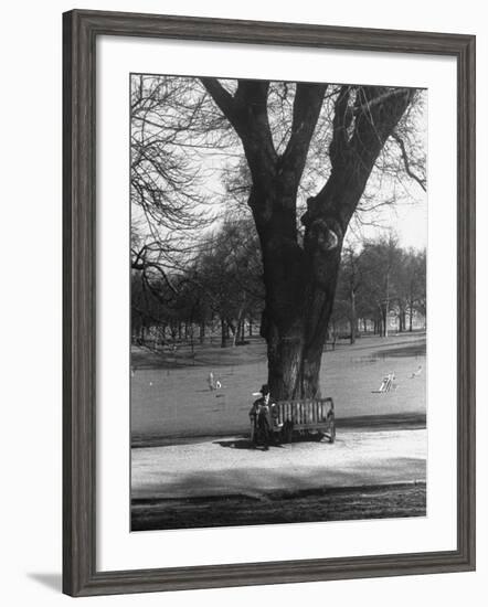 Man Sitting on a Bench and Reading a Newspaper in the Park-Cornell Capa-Framed Photographic Print