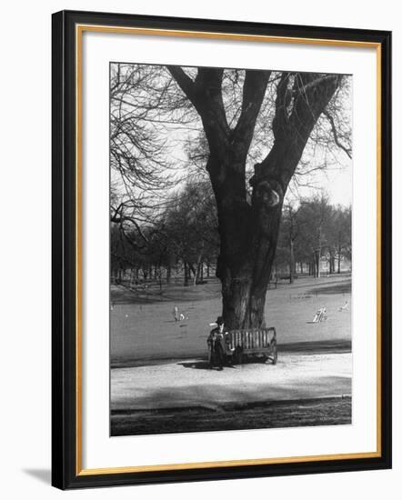 Man Sitting on a Bench and Reading a Newspaper in the Park-Cornell Capa-Framed Photographic Print