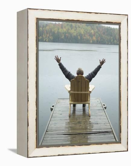 Man Sitting on a Dock with Arms Outstretched-null-Framed Premier Image Canvas