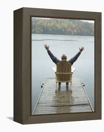 Man Sitting on a Dock with Arms Outstretched-null-Framed Premier Image Canvas