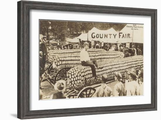 Man Sitting on Giant Ear of Corn-null-Framed Art Print