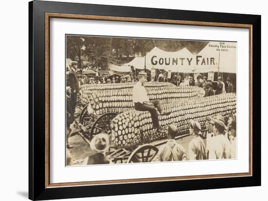 Man Sitting on Giant Ear of Corn-null-Framed Art Print