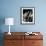 Man Sitting with Oversized Books Holding Sheet Music in His Hands-null-Framed Photo displayed on a wall