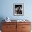 Man Sitting with Oversized Books Holding Sheet Music in His Hands-null-Framed Photo displayed on a wall