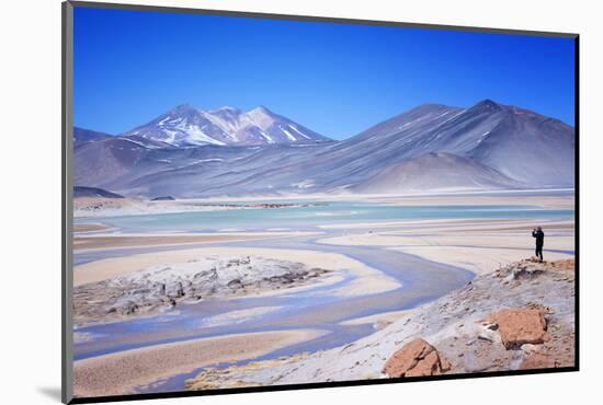 Man Standing on Rocks Looking over Miscanti Laguna, Turquoise Mineral Lake, San Pedro De Atacama-Kimberly Walker-Mounted Photographic Print