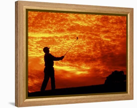 Man Swinging Golf Club at Sunset-Bill Bachmann-Framed Premier Image Canvas