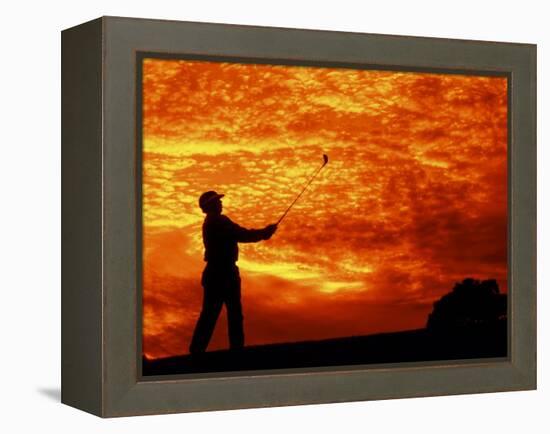 Man Swinging Golf Club at Sunset-Bill Bachmann-Framed Premier Image Canvas