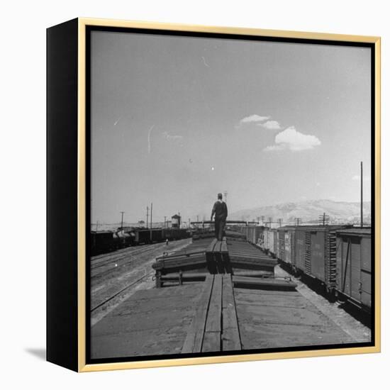 Man Walking Atop a Freight Train Heading Westbound-Sam Shere-Framed Premier Image Canvas