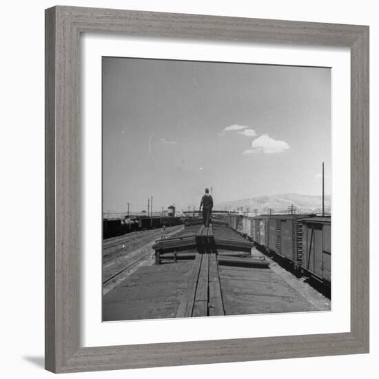 Man Walking Atop a Freight Train Heading Westbound-Sam Shere-Framed Photographic Print