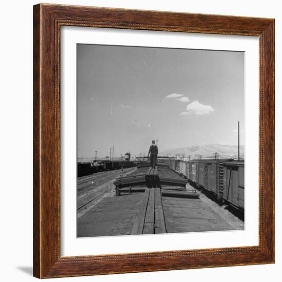 Man Walking Atop a Freight Train Heading Westbound-Sam Shere-Framed Photographic Print