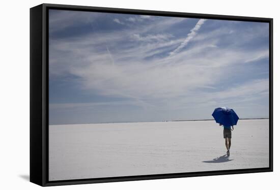 Man Walking With Blue Umbrella On The Bonneville Salt Flats-Lindsay Daniels-Framed Stretched Canvas