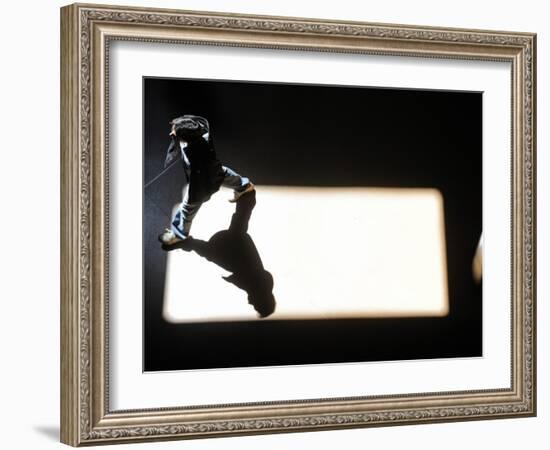 Man Walks Through a Shaft of Sun Light at Atocha Train Station in Madri-null-Framed Photographic Print