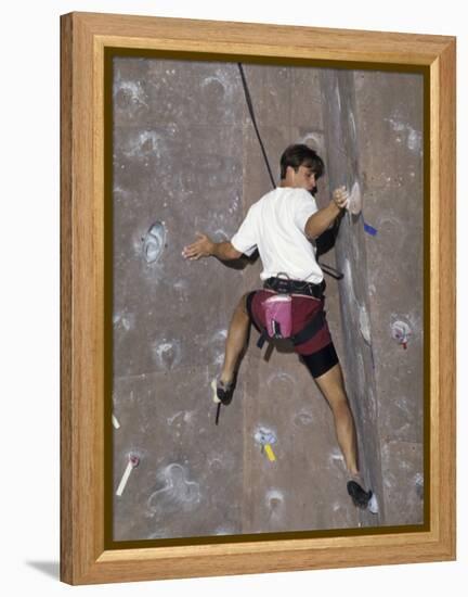 Man Wall Climbing Indoors with Equipment-null-Framed Premier Image Canvas