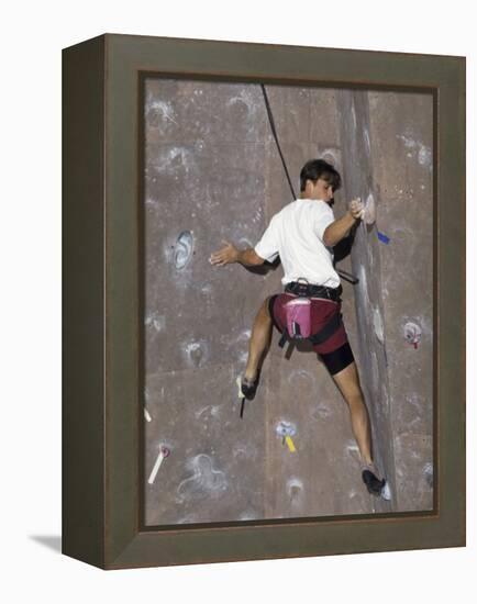 Man Wall Climbing Indoors with Equipment-null-Framed Premier Image Canvas