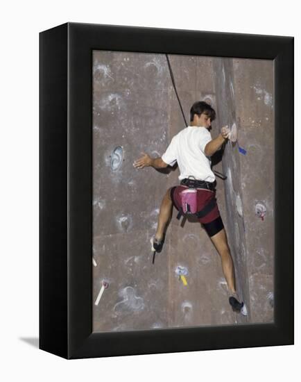 Man Wall Climbing Indoors with Equipment-null-Framed Premier Image Canvas