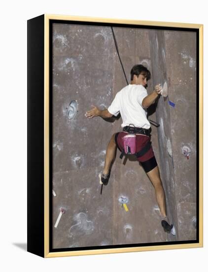 Man Wall Climbing Indoors with Equipment-null-Framed Premier Image Canvas
