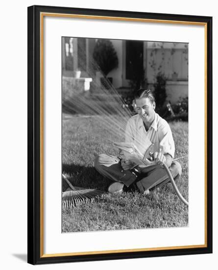 Man Watering the Grass and Reading-null-Framed Photo