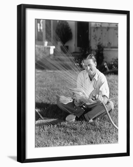 Man Watering the Grass and Reading-null-Framed Photo