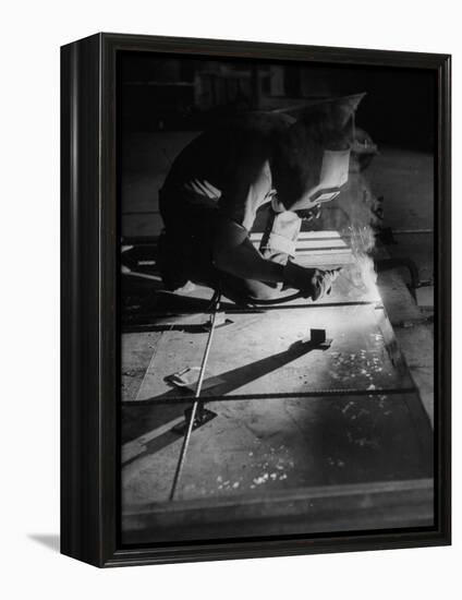 Man Welding Pieces of Metal Together-Allan Grant-Framed Premier Image Canvas