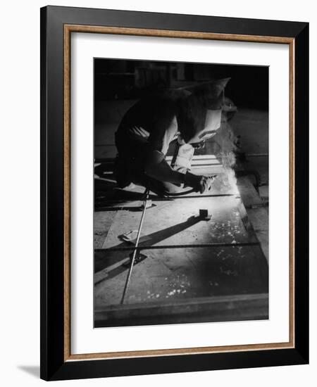 Man Welding Pieces of Metal Together-Allan Grant-Framed Photographic Print