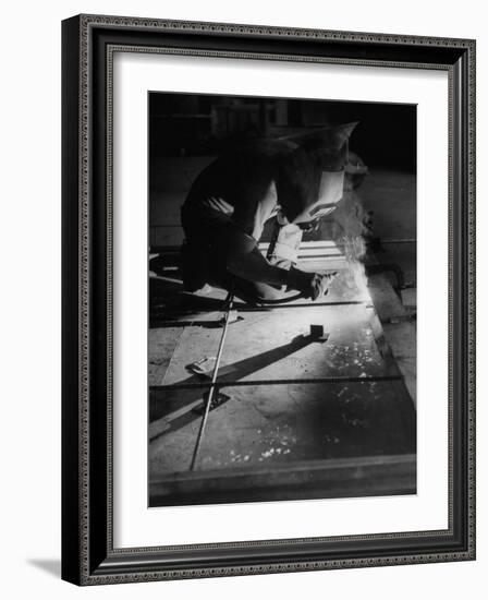 Man Welding Pieces of Metal Together-Allan Grant-Framed Photographic Print