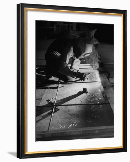 Man Welding Pieces of Metal Together-Allan Grant-Framed Photographic Print